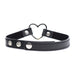 Black vegan leather choker with adjustable snap closures and a metal heart centerpiece.