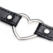 Close-up of black vegan leather choker with silver metal heart centerpiece and stitched detailing.