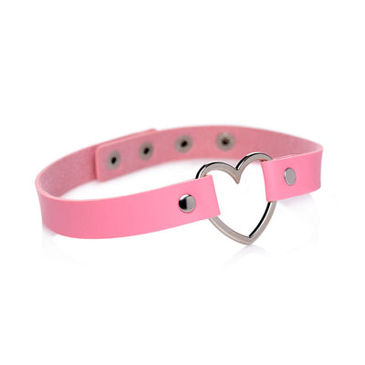 Pink vegan leather choker with a silver metal heart centerpiece and adjustable snap closures on a white background.