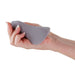 Hand holding a gray Desire Mantra panty vibrator with a textured, flexible silicone design.