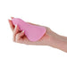 Hand holding a soft pink silicone Desire Mantra panty vibrator with textured surface.