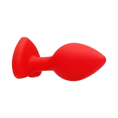 Large red silicone butt plug with a tapered shape and a flared base featuring a diamond-shaped accent.
