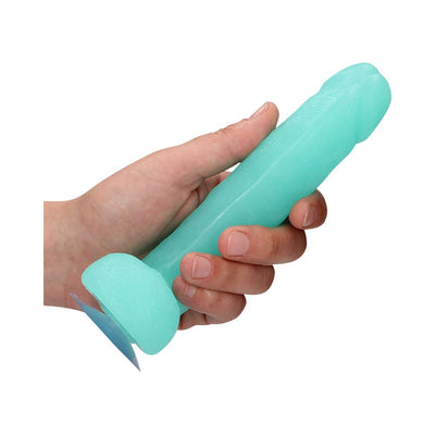 Hand holding a light blue glow-in-the-dark novelty soap shaped with textured details and a suction base.