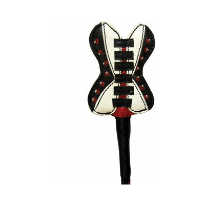 Close-up of a corset-shaped leather crop tip in black, white, and red with decorative stitching and studs.