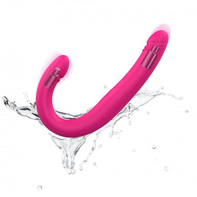 Pink flexible double-ended vibrator with dual motors shown with water splash on white background.