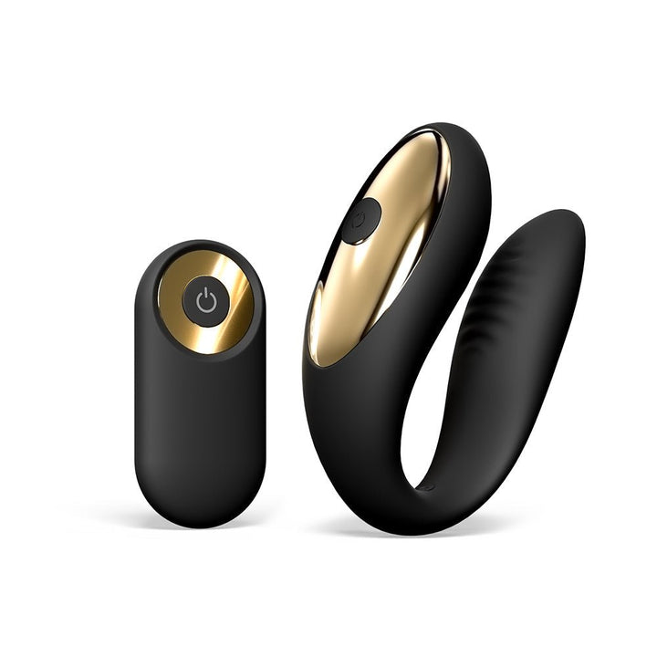 Black and gold ergonomic couple’s vibrator with matching remote control on white background