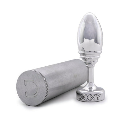 Polished silver ribbed Doxy plug with flat base next to a matching brushed aluminum storage case on white background.