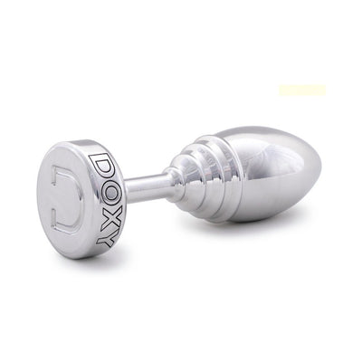 Polished silver ribbed metal plug with tapered shape and flat base engraved with DOXY logo on white background.