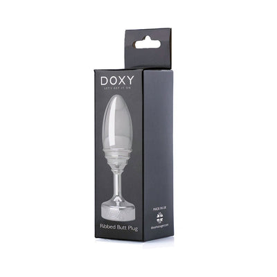 Doxy Ribbed Butt Plug in clear solid aluminum displayed in sleek black packaging with product image and branding.