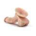 Beige realistic dildo with balls and suction cup base for hands-free use on white background.