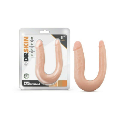 Dr. Skin Mini Double Dong in flesh tone with two different-sized ends, shown in packaging and outside on white background.