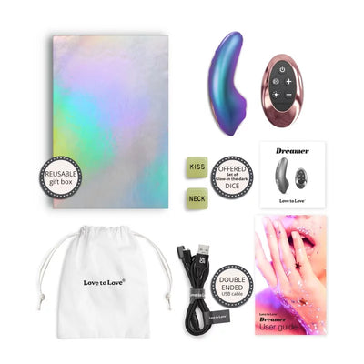 Love To Love Dreamer iridescent berry vibrator with remote, reusable gift box, glow-in-the-dark dice, USB charging cable, storage pouch, and user guide.