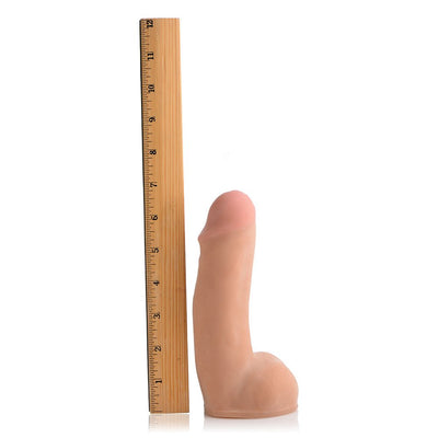 Beige dual density realistic dildo standing next to a wooden ruler showing 6.5 inches length.