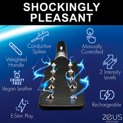 Black vegan leather e-stim paddle with conductive metal spikes and weighted handle, featuring two intensity levels and rechargeable design.