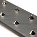 Close-up of black vegan leather paddle with shiny metal spikes for e-stim sensation play.