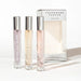 Set of three Eye of Love pheromone perfume sprays with sleek silver caps and elegant packaging.