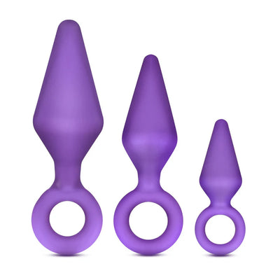 Three purple silicone anal training plugs in small, medium, and large sizes with ring handles for easy use.