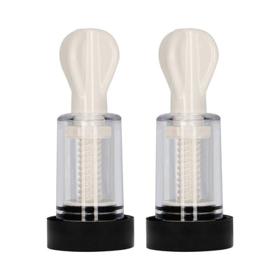 Pair of white and transparent electro nipple twisters with black bases, designed for adjustable suction and stimulation.