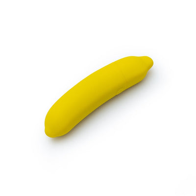 Compact yellow silicone vibrator shaped like a banana with smooth, curved design and USB charging port.