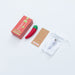 Chili Pepper shaped red and green vibrator with packaging, colorful instruction card, USB charging cable, and white storage pouch on white background.