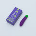 Purple eggplant-shaped vibrator with green top next to its purple and green packaging box on a white background.