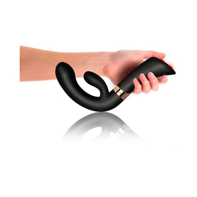 Hand holding sleek black ergonomic dual-motor vibrator with flexible G-spot shaft and clitoral stimulator.