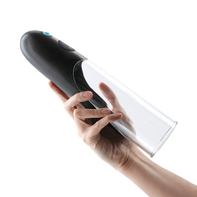 Hand holding the black Enlarge Colossus Pump with clear cylinder and control buttons on white background.