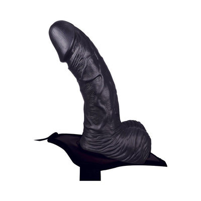 Black adjustable hollow strap-on dildo with realistic texture and attached harness base.