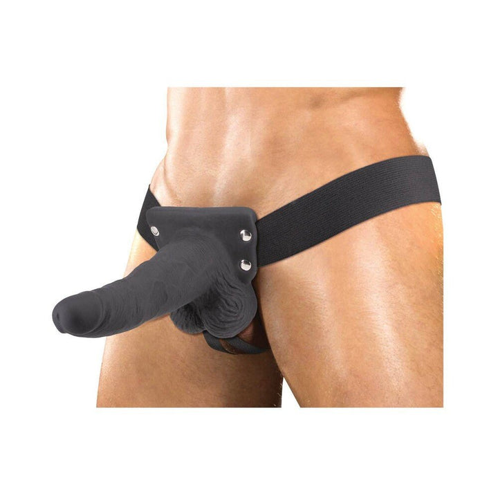 Black hollow strap-on vibrator with adjustable waistband worn on a male model's hips.