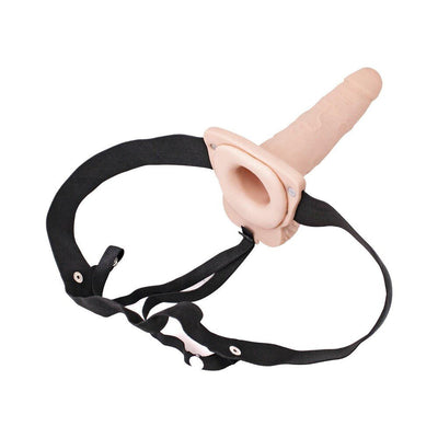 Adjustable black strap-on harness with a flesh-toned hollow vibrating dildo attachment.