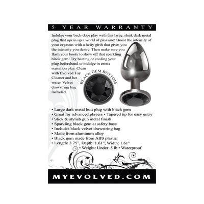 Sleek large dark metal anal plug with tapered tip and sparkling black gem base, shown with product details and warranty information.