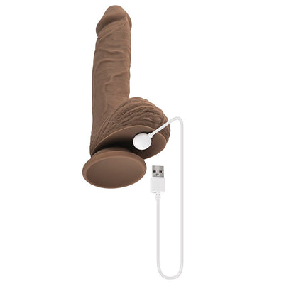Dark silicone realistic dildo with suction base and USB rechargeable magnetic charging cable attached.