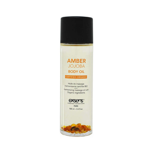 Bottle of EXSENS Amber Jojoba organic body oil with amber stones at the base, 100 ml size with black cap.