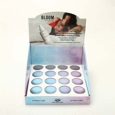 Empty Eye of Love Bloom pheromone room spray cardboard display with color-coded slots for testers.