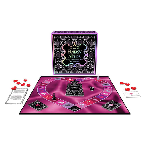 Fantasy Affairs board game set with heart-shaped game board, cards, dice, and red heart tokens on a pink background.