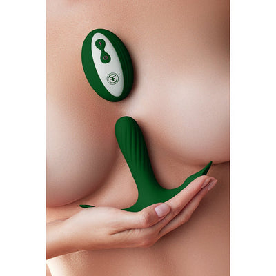 Dark green Femme Funn Ossia wearable vibrator with wireless remote shown on a model's hand and chest.