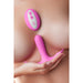 Pink Femme Funn Ossia wearable vibrator with wireless remote shown on a model's chest, highlighting its compact, ergonomic design.