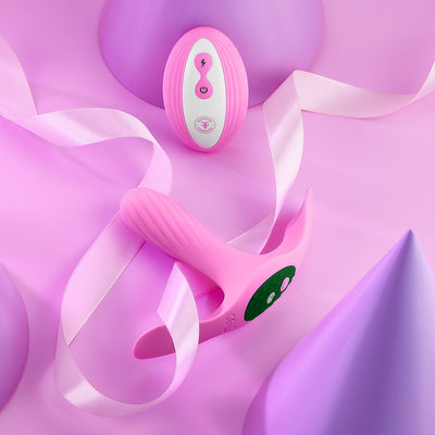 Pink Femme Funn Ossia wearable vibrator and matching wireless remote on a pastel purple and pink background with ribbon accents.