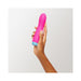 Hand holding a pink FemmeFunn Rora rechargeable silicone rotating bullet vibrator with a blue base against a white background.