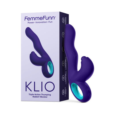 Dark purple FemmeFunn Klio triple action thumping rabbit vibrator with ergonomic handle and curved design next to its packaging box.