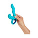 Hand holding a blue ergonomic triple-action vibrator with curved insertable tip and external stimulator ring.