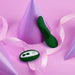 Green FemmeFunn Unda panty vibrator with wireless remote on pink background with purple cones and pink ribbon.