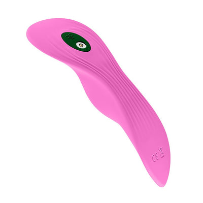 Pink ergonomic FemmeFunn Unda panty vibrator with textured surface and charging port detail on white background.