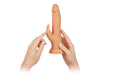 Hands holding a flesh-toned wireless Turbo Rabbit vibrator with dual stimulating heads and realistic design.
