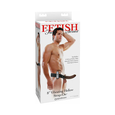 Packaging of Fetish Fantasy Series 8-inch vibrating hollow strap-on with adjustable elastic harness shown on male model.