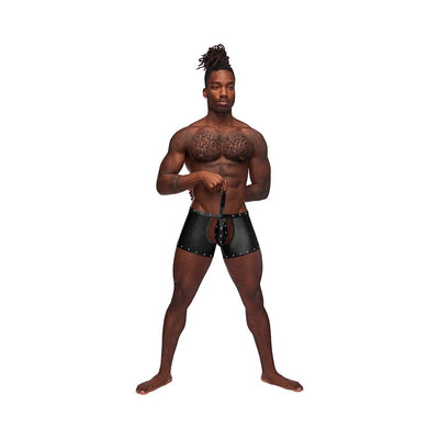 Male model wearing black nylon spandex tear-off cup thong shorts with studded detailing and a front strap.