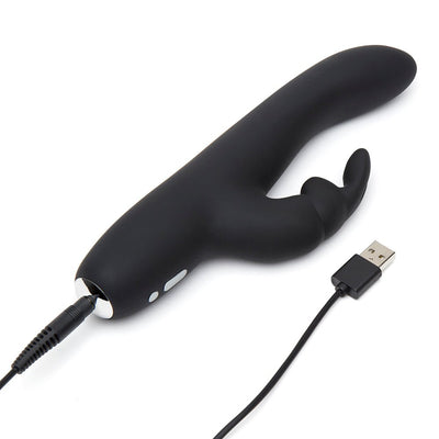 Black slimline rabbit vibrator with dual stimulation ears, shown with USB charging cable connected on white background.