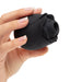 Hand holding a black rose-shaped clitoral suction stimulator with soft silicone petals and a central suction opening.