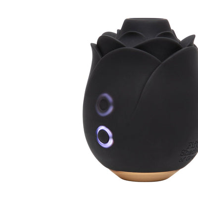 Black rose-shaped clitoral stimulator with illuminated control buttons and gold base from Fifty Shades of Grey collection.