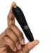 Hand holding a compact black Fifty Shades of Grey branded We-Vibe Tango X vibrator with control buttons.